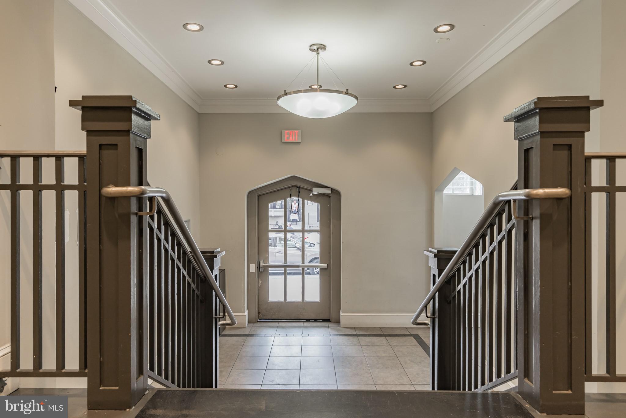 1451 Park Road Northwest, Unit 303 Washington, DC 20010 - Photo 20 of 27 a view of a hallway with windows and stairs