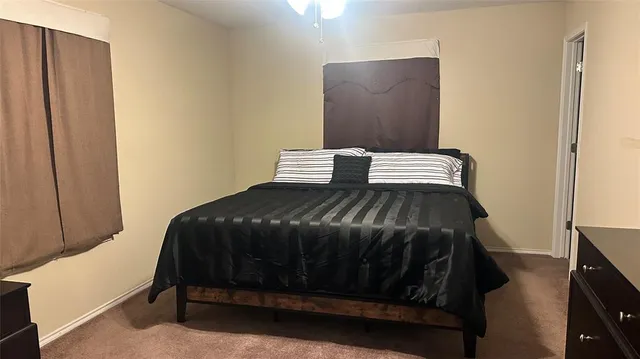 a bedroom with a bed and a dresser