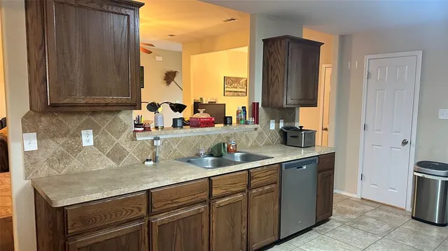 a kitchen with a sink and a refrigerator