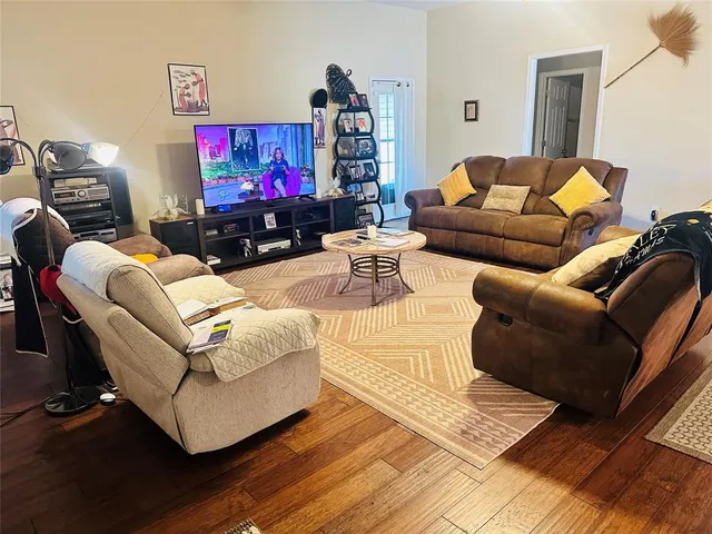a living room with furniture and a flat screen tv