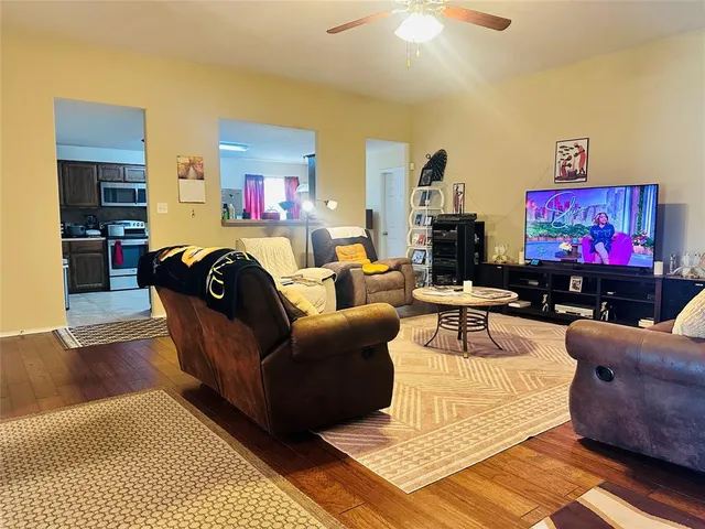 a living room with furniture and a flat screen tv
