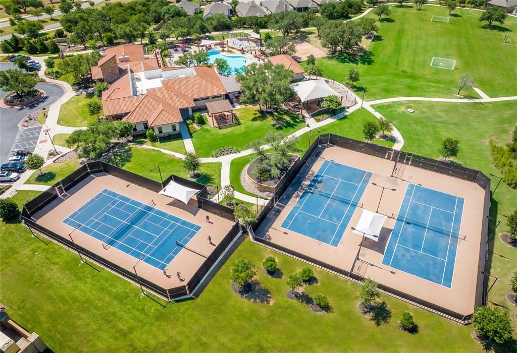 4201 Vespa Cove Leander, TX 78641 - Photo 23 of 29 an aerial view of a tennis ground and a cars park side of the road