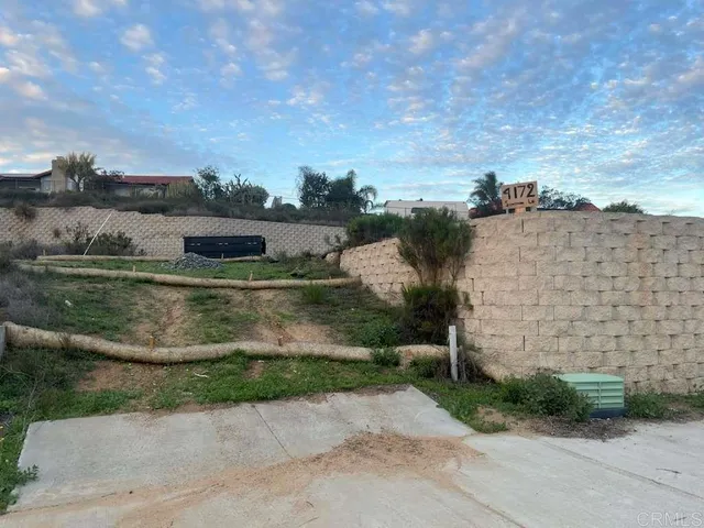 an aerial view of residential houses with outdoor space and lake view