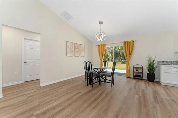 a dining room with furniture and wooden floor