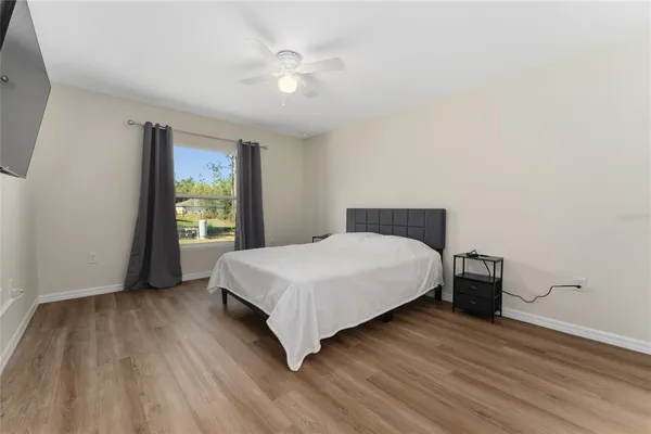 a bedroom with a bed and window