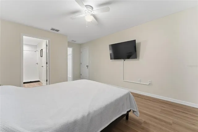 a bedroom with a bed and a flat screen tv