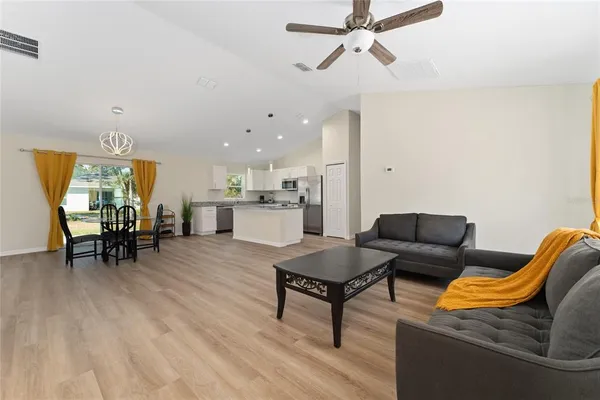a living room with furniture and kitchen view