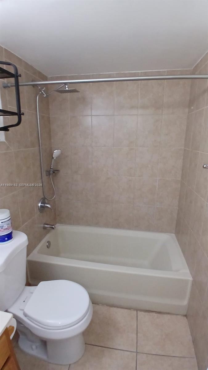 8782 Southwest 12th Street, Unit 208 Miami, FL 33174 - Photo 11 of 16 a bathroom with a toilet and a bath tub