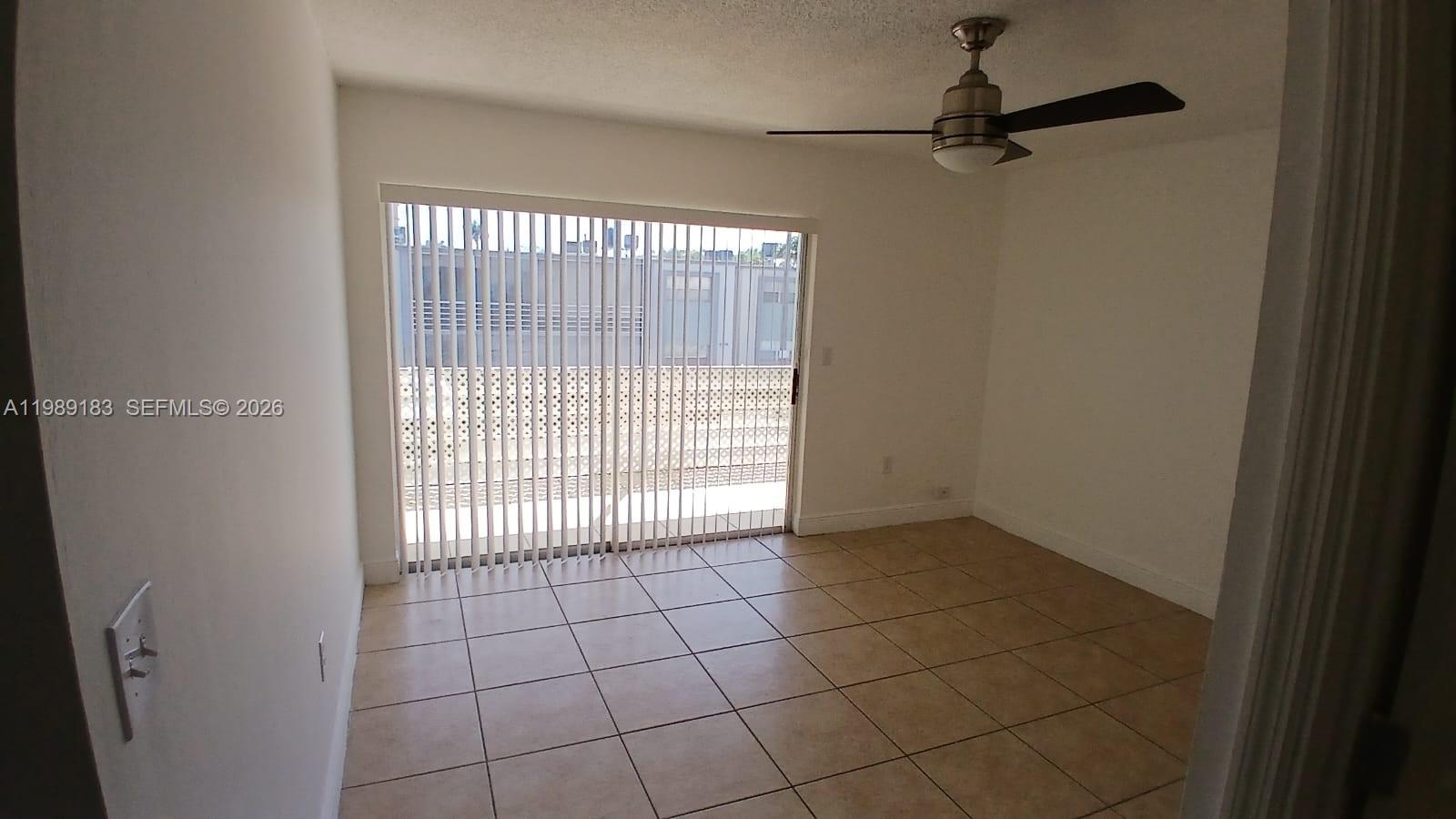 8782 Southwest 12th Street, Unit 208 Miami, FL 33174 - Photo 12 of 16 a view of an empty room and a window