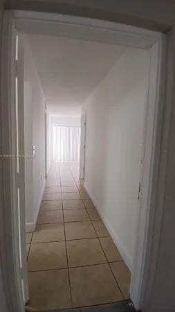 a view of hallway with a ceiling fan
