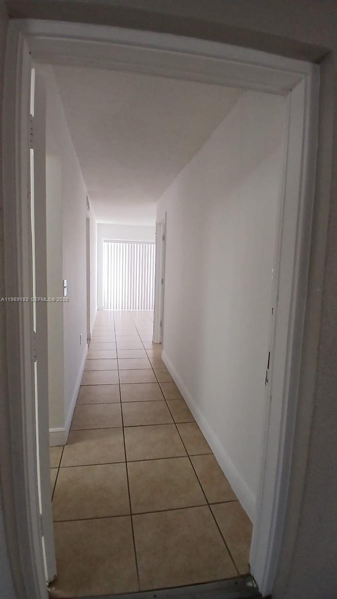 8782 Southwest 12th Street, Unit 208 Miami, FL 33174 - Photo 13 of 16 a hallway with a window