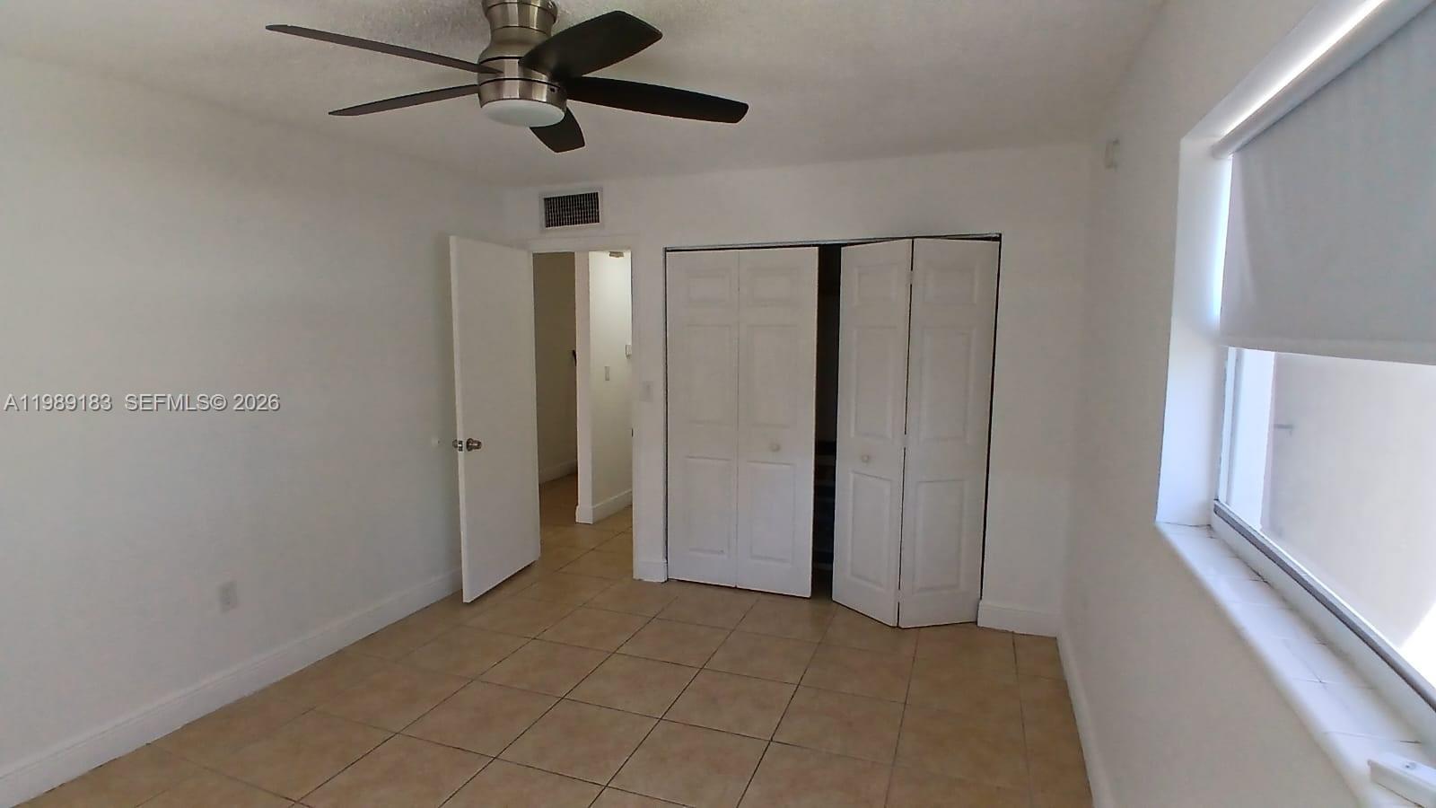 8782 Southwest 12th Street, Unit 208 Miami, FL 33174 - Photo 15 of 16 a view of hallway with a ceiling fan
