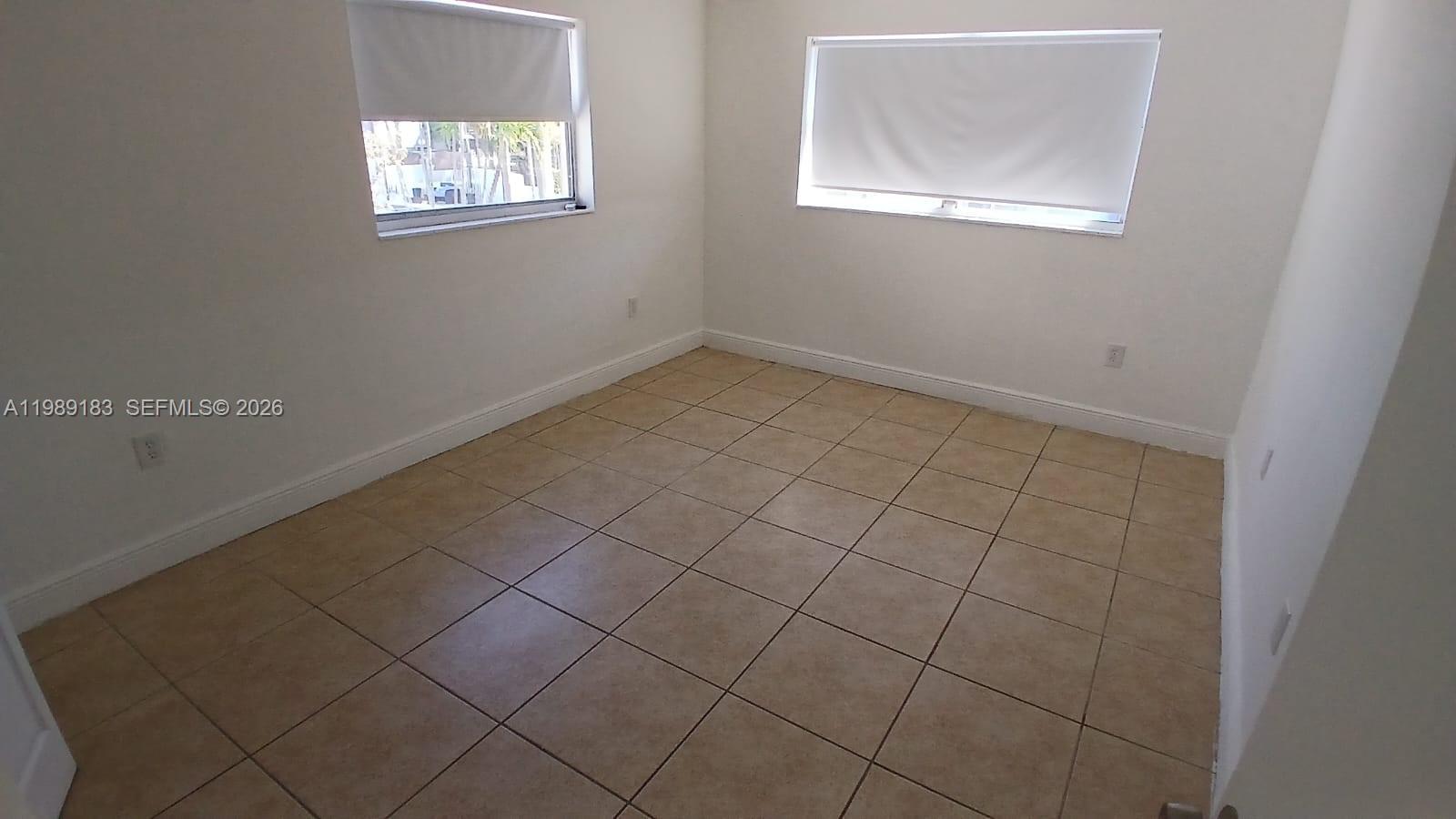 8782 Southwest 12th Street, Unit 208 Miami, FL 33174 - Photo 2 of 16 an empty room with windows