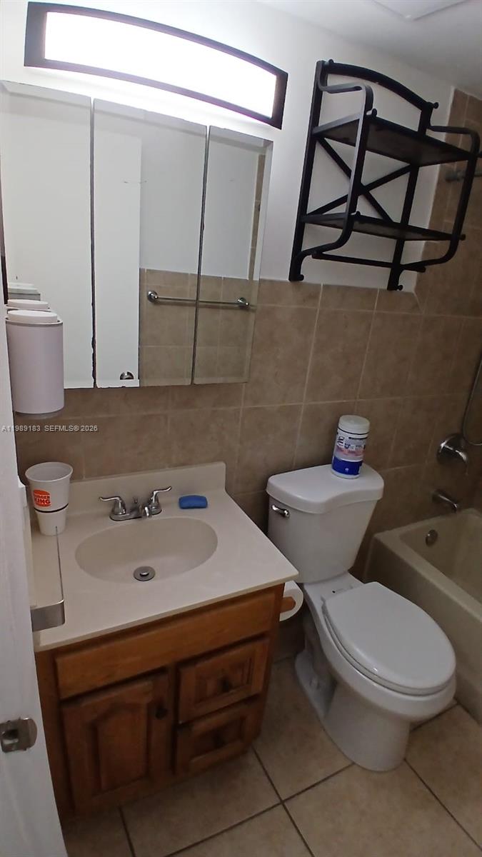 8782 Southwest 12th Street, Unit 208 Miami, FL 33174 - Photo 4 of 16 a white toilet sitting next to a bathroom sink