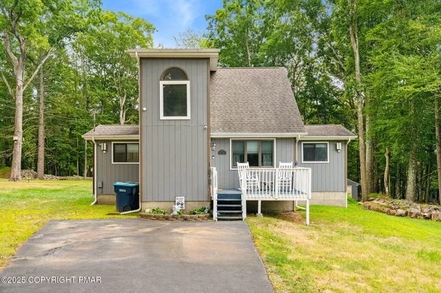 a view of a house with a backyard patio and swimming pool