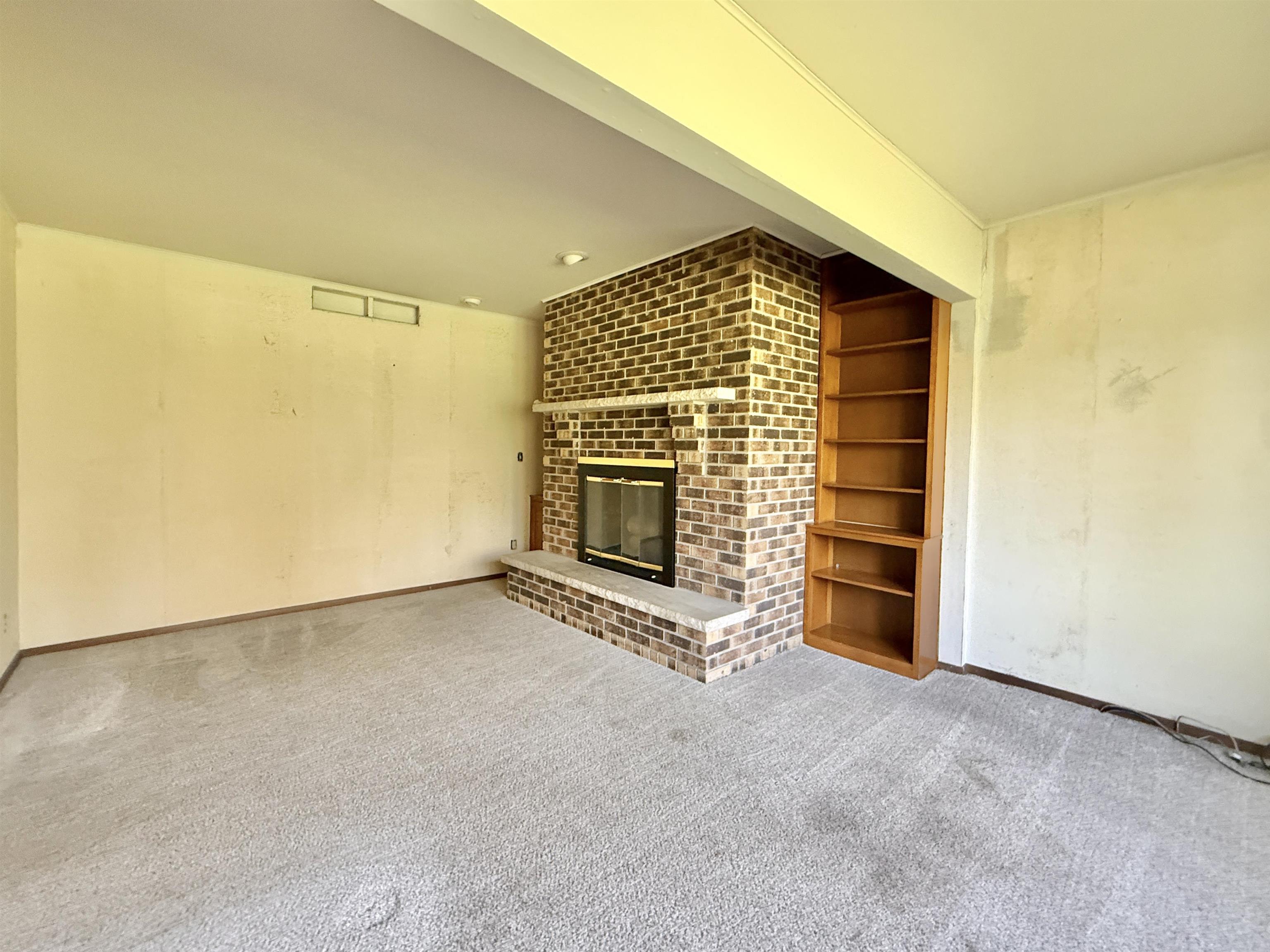 3620 Valerie Road Roscoe, IL 61073 - Photo 8 of 26 a view of an empty room with a fireplace