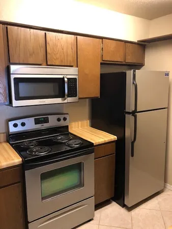 a kitchen with granite countertop cabinets and steel stainless steel appliances