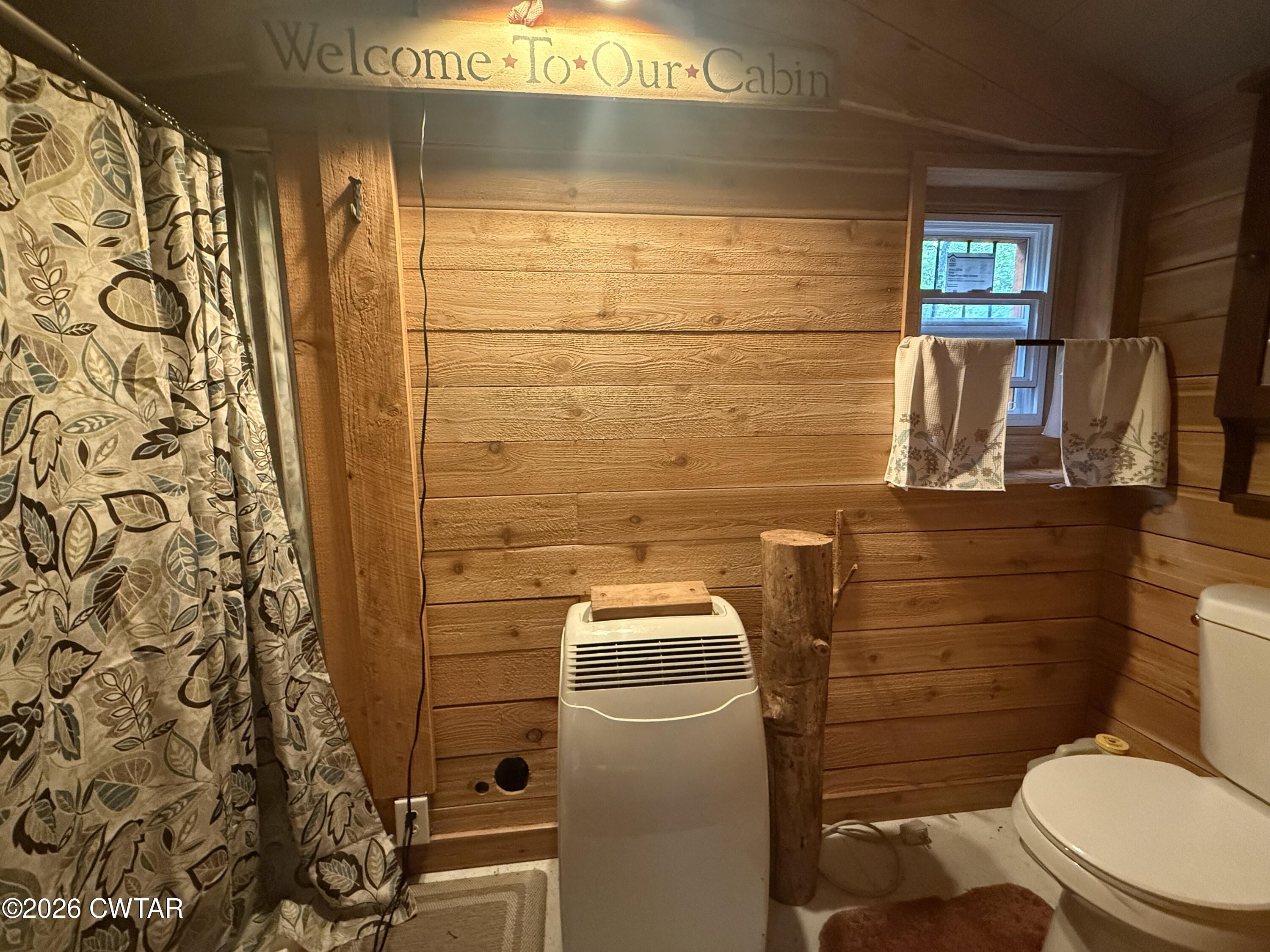1782 Smith Chapel Road Decaturville, TN 38329 - Photo 12 of 22 a bathroom with a toilet and a shower