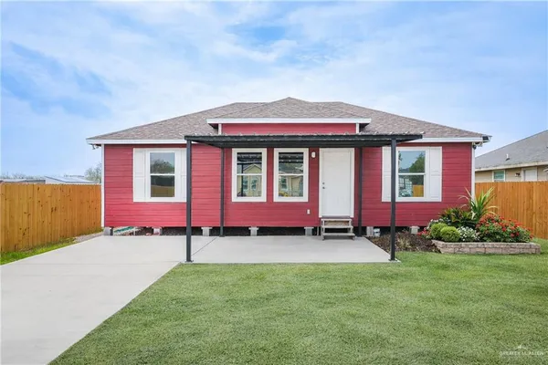 a front view of a house with a garden and yard
