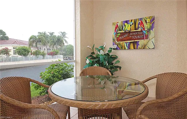 a dining room with furniture and a potted plant