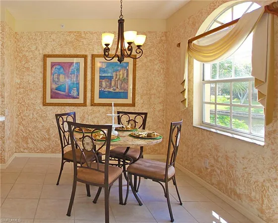 a view of a dining room with furniture and a chandelier