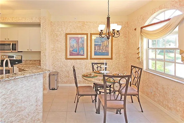 a view of a dining room with furniture and a window