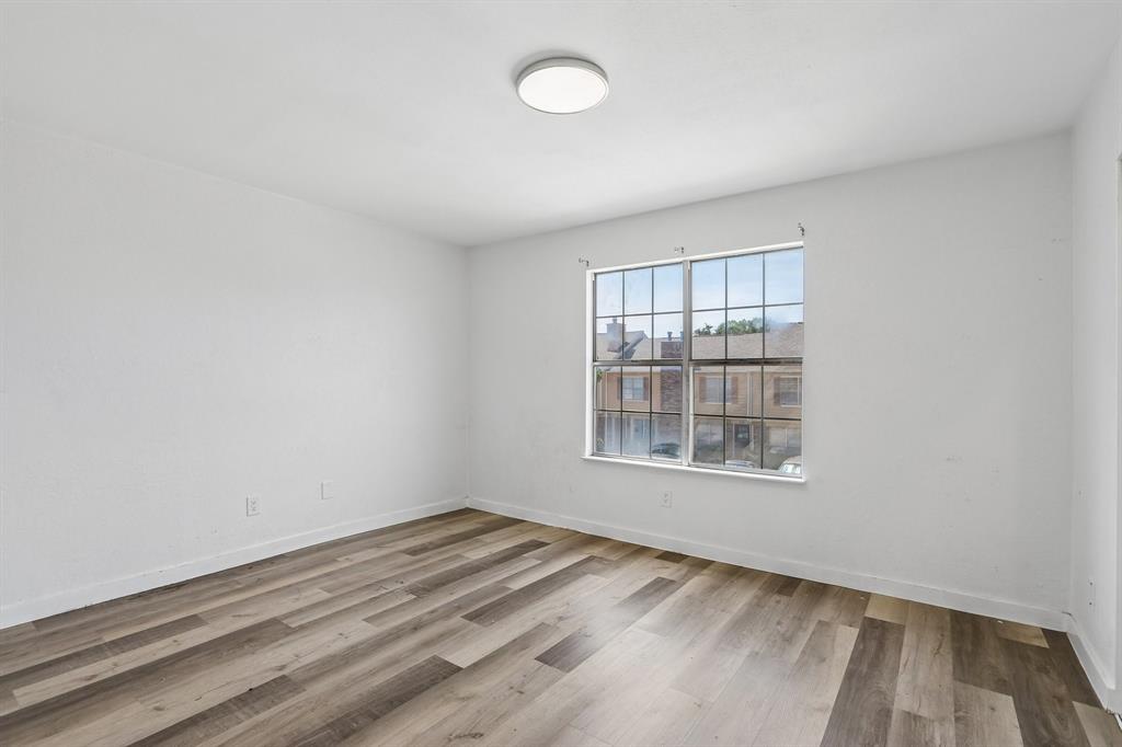 2400 Jupiter Road, Unit 6 Plano, TX 75074 - Photo 14 of 22 Neutral white walls complement the wood-finish flooring