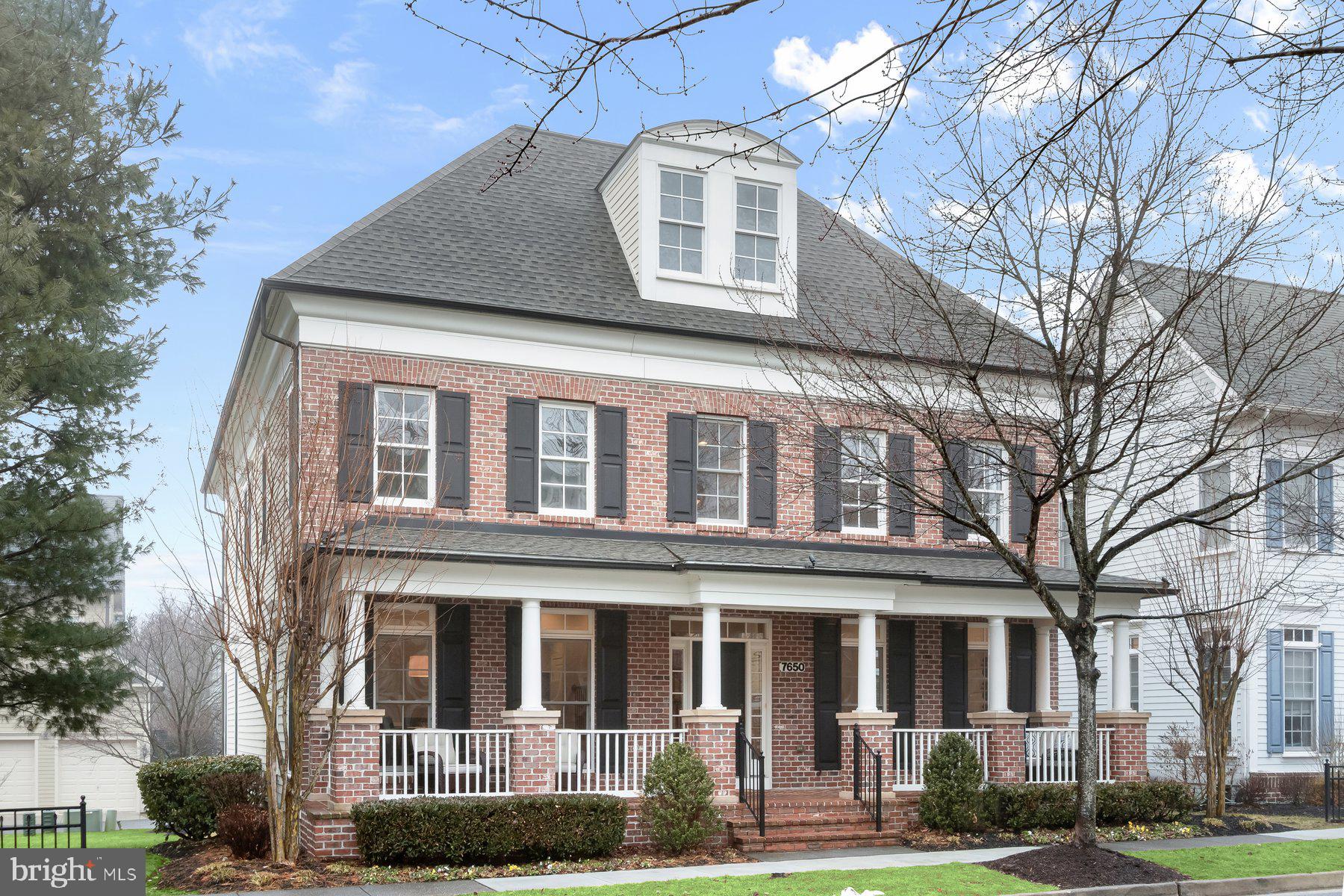 a front view of a residential apartment building with a yard