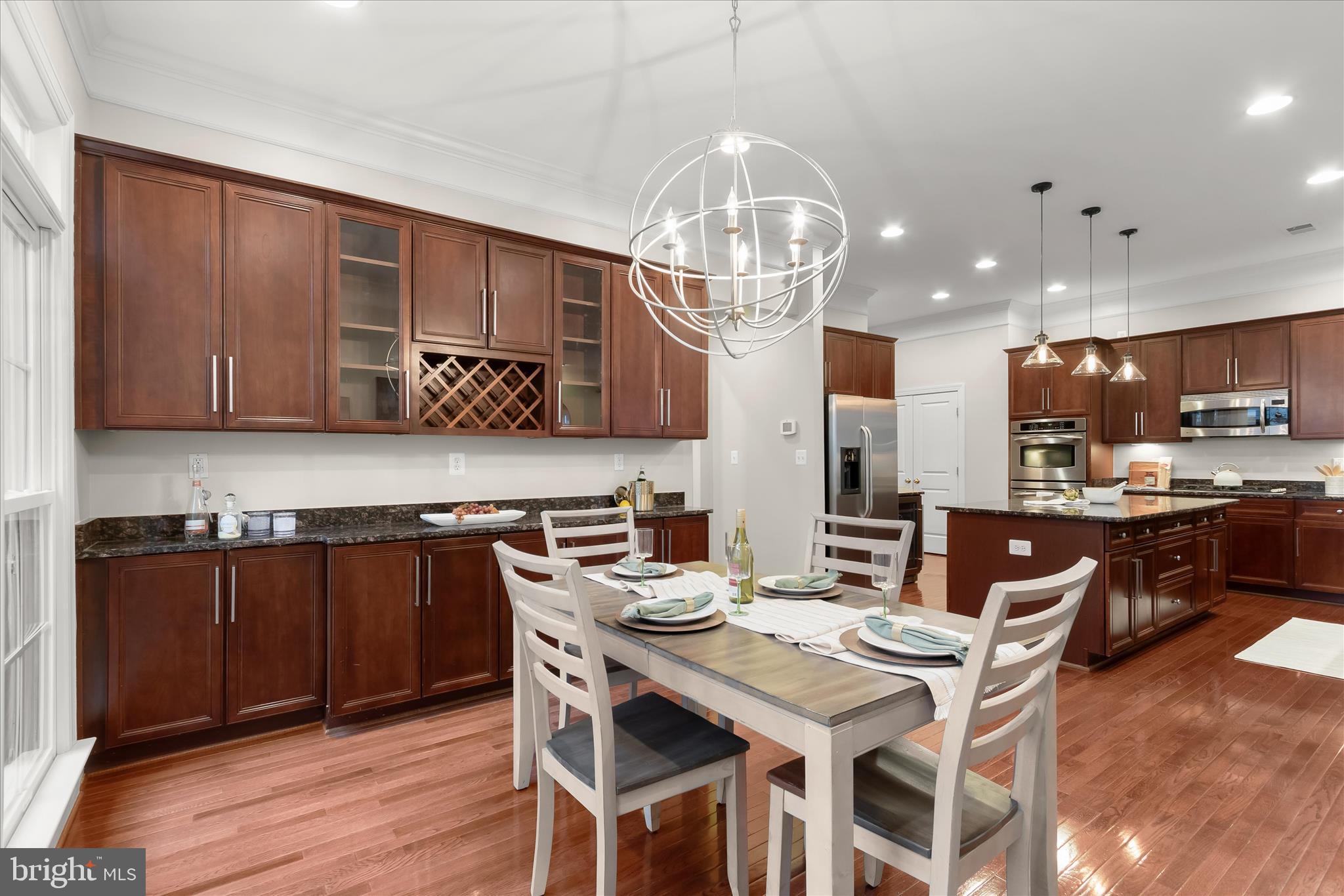 7650 Midtown Road Fulton, MD 20759 - Photo 22 of 76 a kitchen with a dining table chairs stainless steel appliances and cabinets