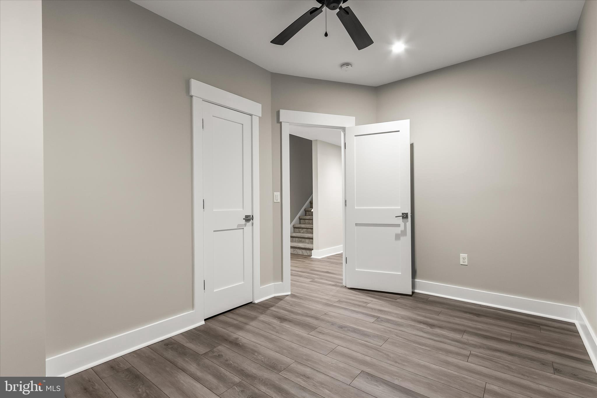 7650 Midtown Road Fulton, MD 20759 - Photo 45 of 76 an empty room with wooden floor and natural light