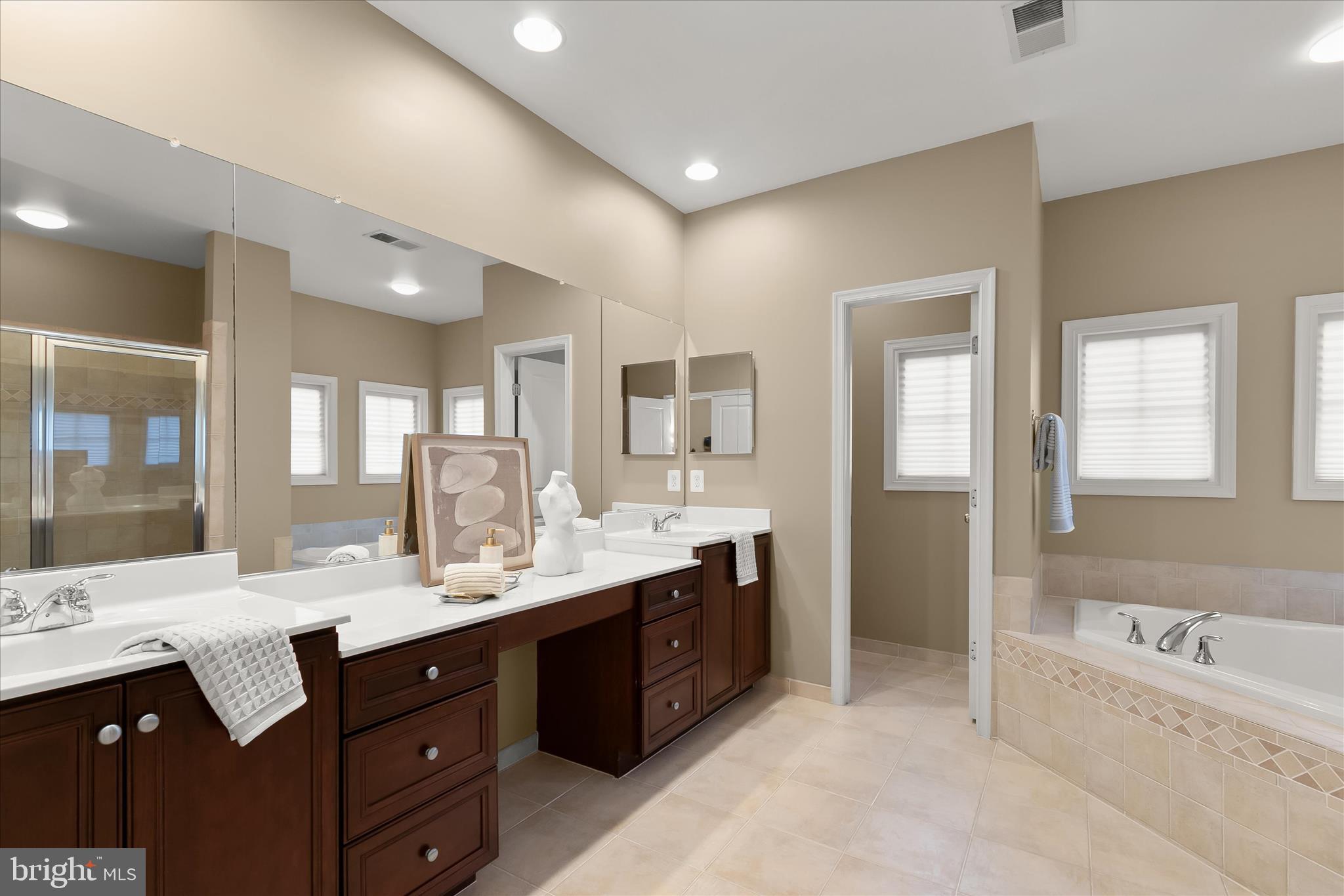7650 Midtown Road Fulton, MD 20759 - Photo 53 of 76 a large bathroom with a double vanity sink large mirror and a bathtub