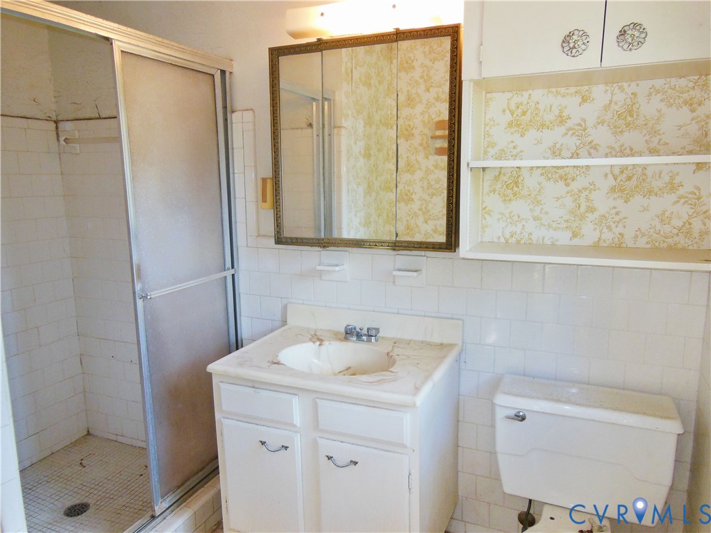 8218 Overbury Road Richmond, VA 23227 - Photo 27 of 37 a bathroom with a sink a toilet and shower