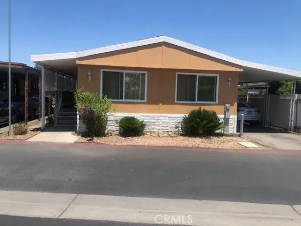 a front view of a house with a yard and glass windows