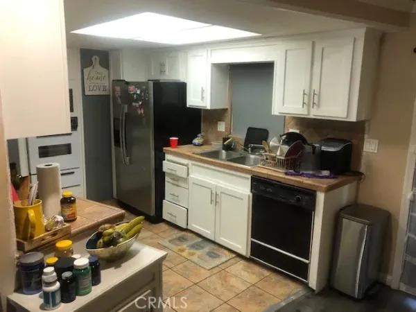 a kitchen with a sink stove and refrigerator