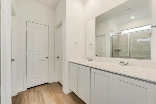 a bathroom with a double vanity sink and a mirror