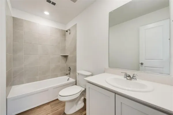 a bathroom with a sink a toilet and a bathtub