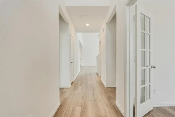 a view of a hallway with wooden floor