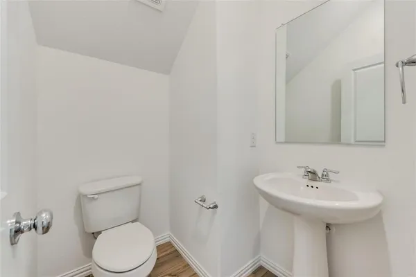 a white toilet sitting next to a bathroom sink