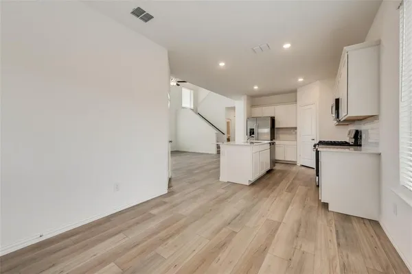 a view of kitchen with furniture and wooden floor