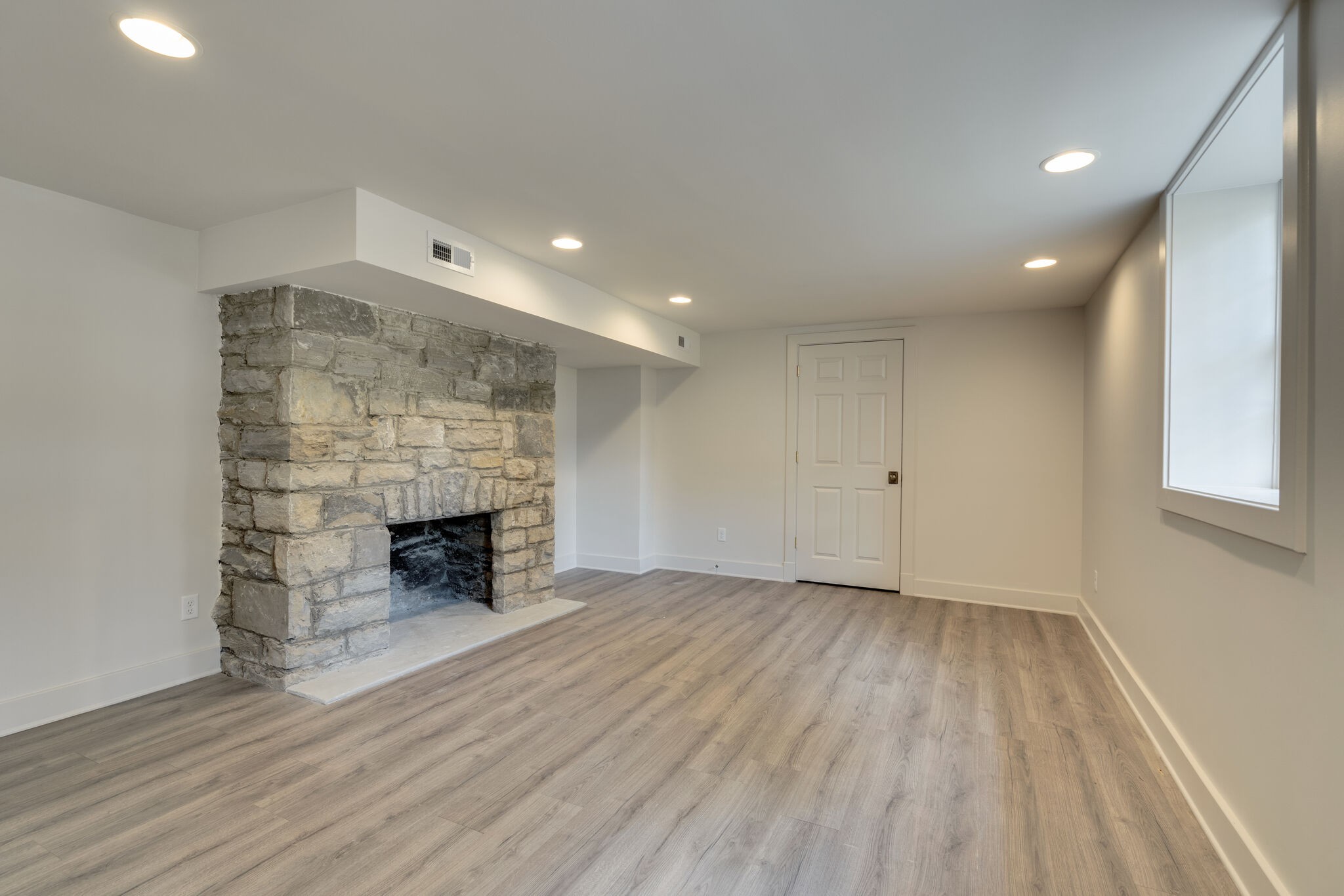 249 Lauderdale Road Nashville, TN 37205 - Photo 53 of 66 an empty room with wooden floor fireplace and windows