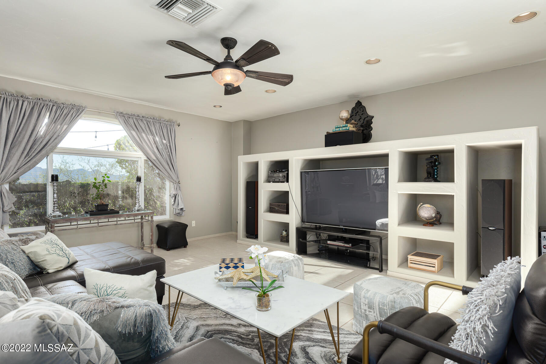 317 Valley View Drive Rio Rico, AZ 85648 - Photo 22 of 49 a living room with furniture a ceiling fan and a flat screen tv