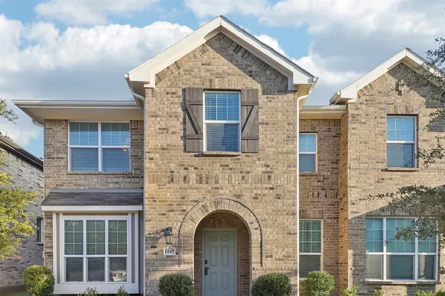 a view of a house with large windows