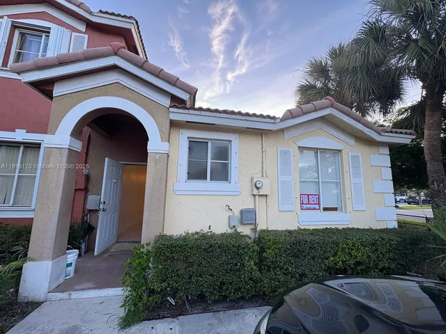a front view of a house with yard