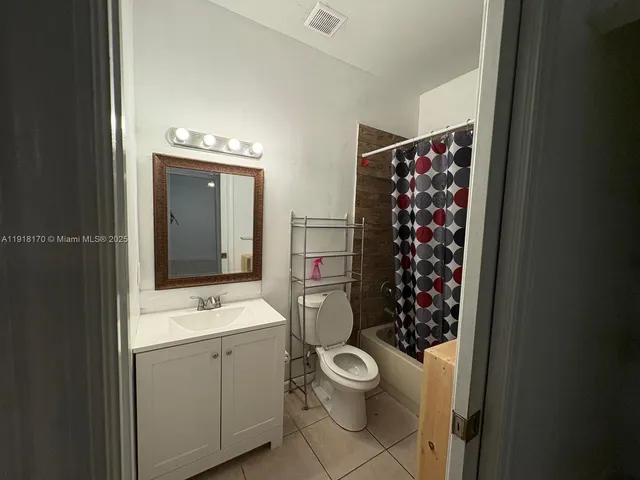 a bathroom with a toilet sink and shower