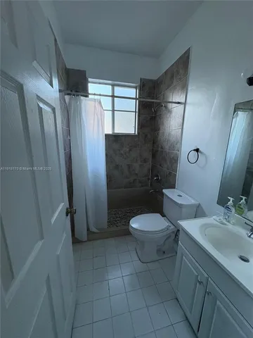 a bathroom with a toilet sink and shower