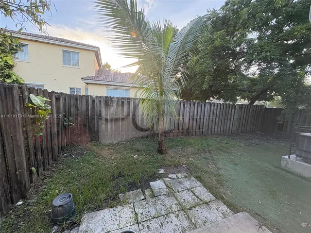 a kitchen with a refrigerator and a sink