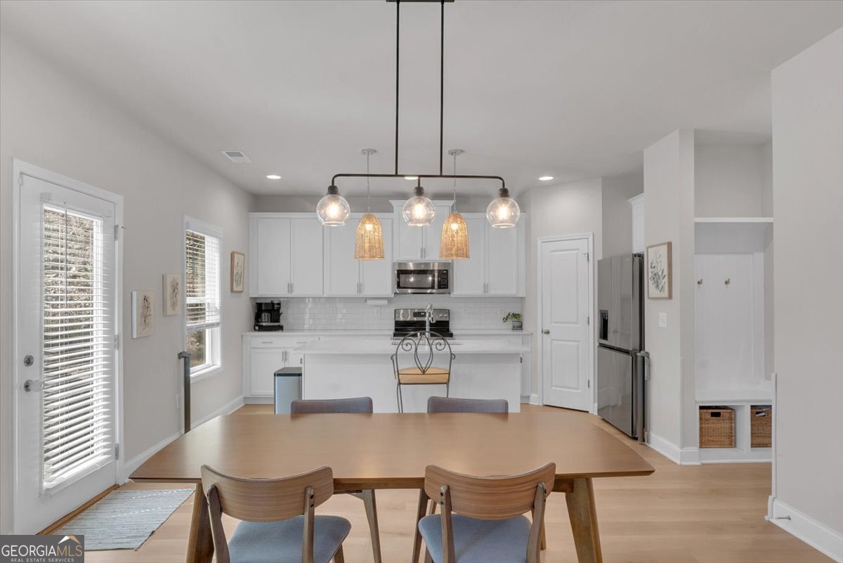 2099 Easterwood Court Decatur, GA 30032 - Photo 11 of 38 a kitchen with stainless steel appliances a dining table chairs and refrigerator