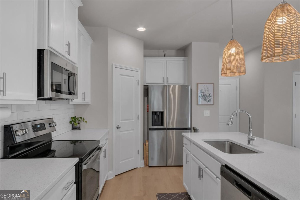2099 Easterwood Court Decatur, GA 30032 - Photo 13 of 38 a kitchen that has a sink a refrigerator and a stove top oven