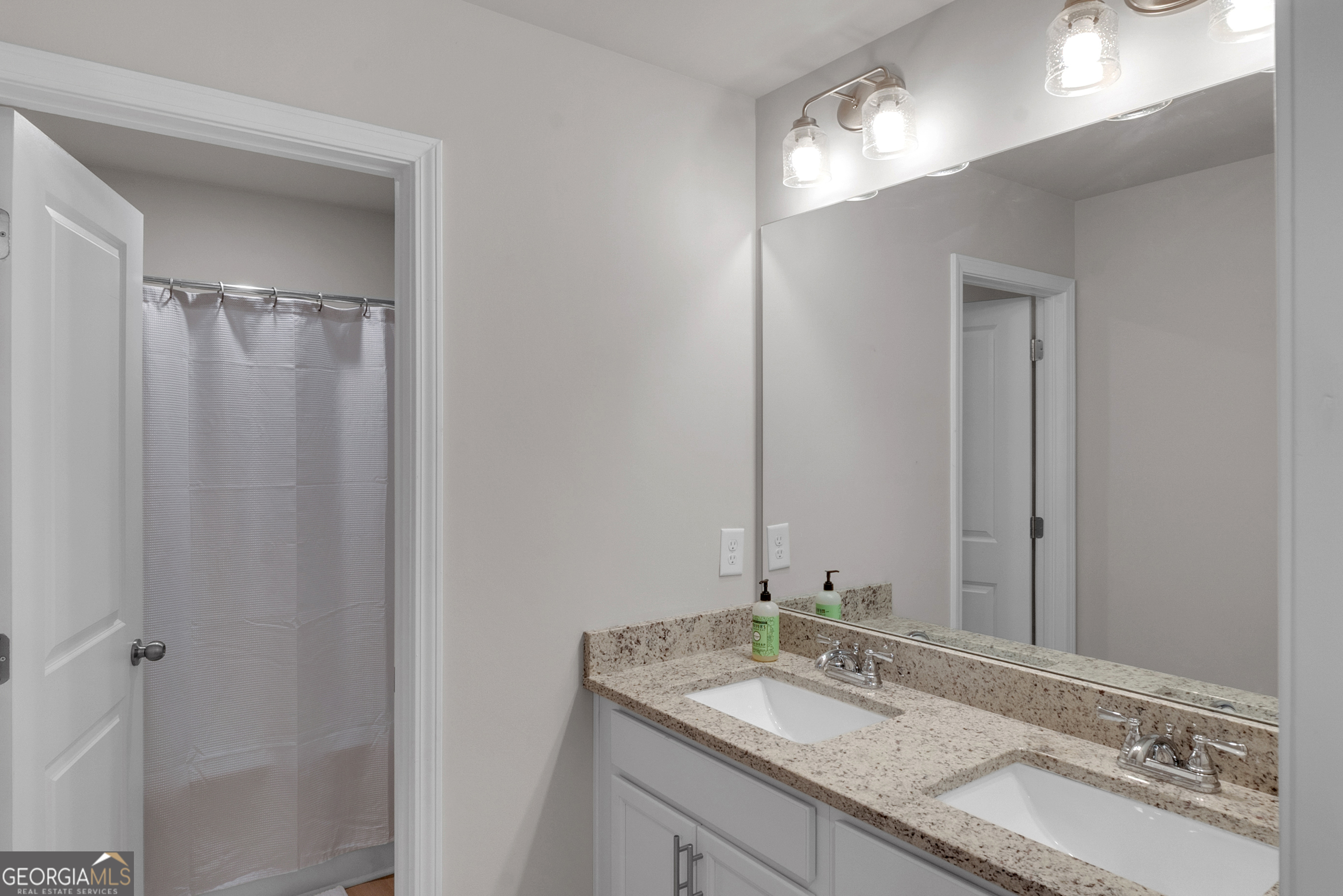 2099 Easterwood Court Decatur, GA 30032 - Photo 26 of 38 a bathroom with a granite countertop sink and a mirror