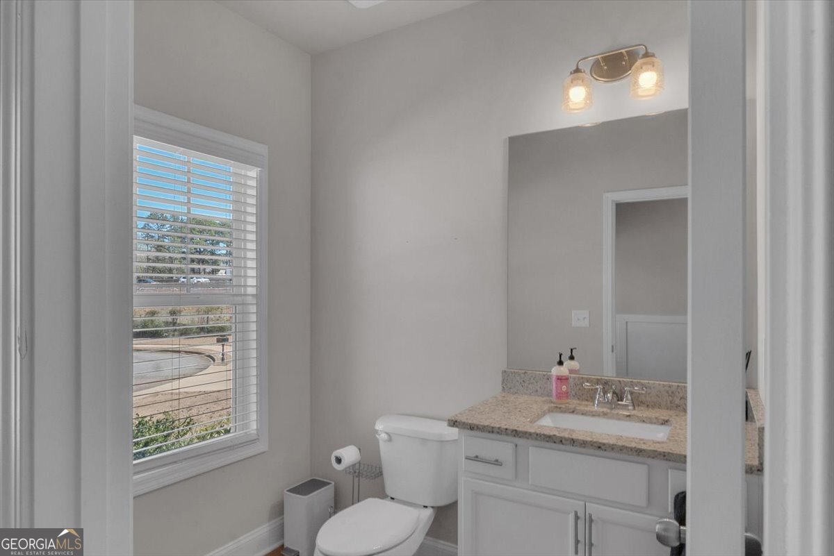 2099 Easterwood Court Decatur, GA 30032 - Photo 7 of 38 a bathroom with a toilet sink vanity and mirror